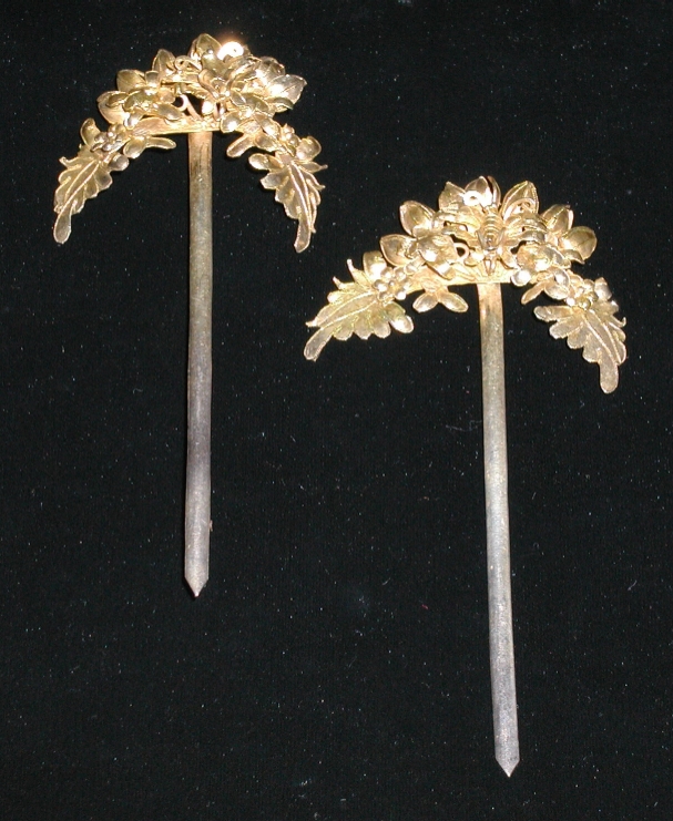 A pair of gilded hairpins.